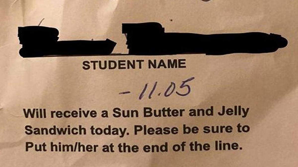 This note was given to a student at Harrisonville Elementary School, according to the student’s parent. Sending a student to the back of the line is not mentioned in the district’s policy for dealing with low funds in students’ meal accounts.
