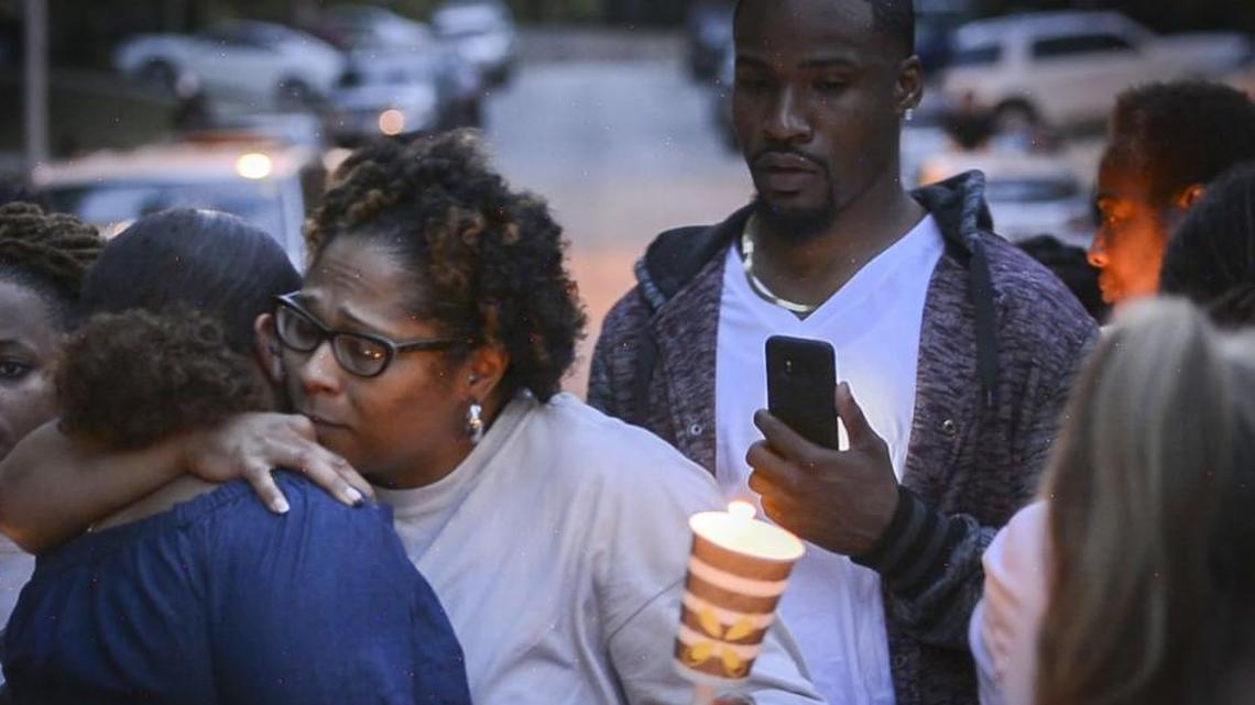 LaToya Thomas (middle) at a candlelight vigil to remember her daughter Gemesha Thomas, who shot herself at school and later died, and to raise awareness for suicide prevention.