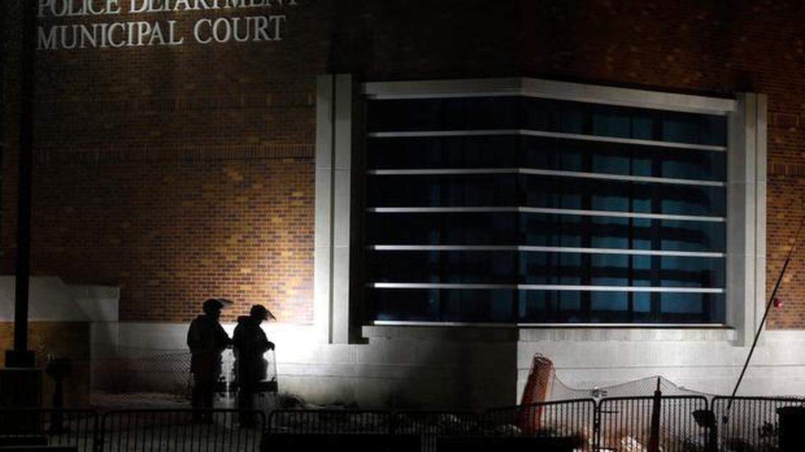 
In this Nov. 26, 2014, file photo, nembers of Missouri National Guard stand outside of the Ferguson Police Department and the Municipal Court in Ferguson, Mo. A Justice Department investigation has found patterns of racial bias in the Ferguson police department and at the municipal jail and court. The Missouri Supreme Court on Monday assigned an appellate judge to hear all pending and future cases of the Ferguson Municipal Court.
