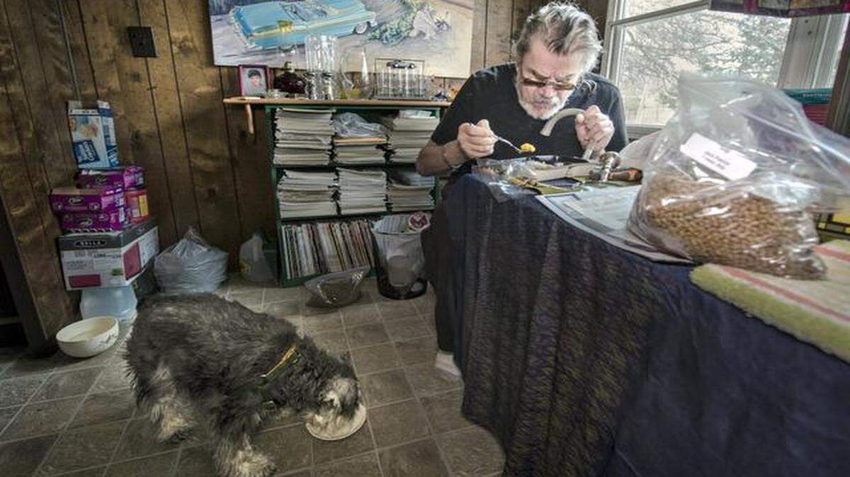 
Jack Patrick and his 7-year-old schnauzer, Andy, eat meals brought to their Warrensburg, Mo., home. Organizations that cater to the elderly and disabled have increasingly begun providing pet food so their clients get proper nutrition and don't have to give up their animal companions.

