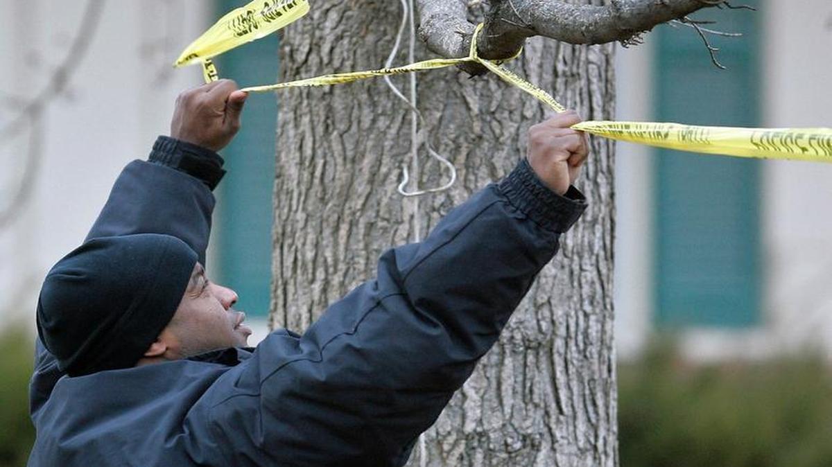 An officer adjusted a crime scene tape in February 2007 at the home of Linda J. Friday, 55, who was shot and killed by police.