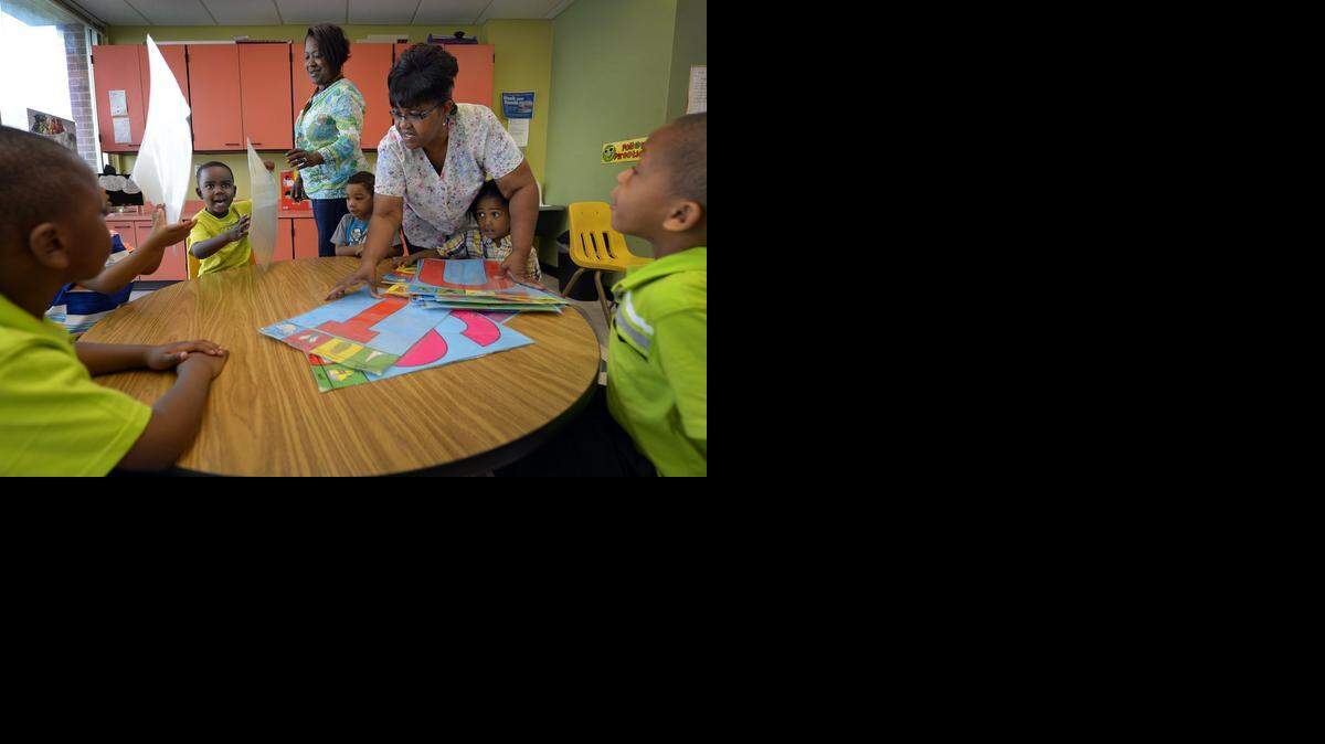 
Teacher Stephanie Meade (left) and assistant teacher Rosalyn Logan worked on letter identification with youngsters at the Alphabet Academy Learning Center. Students include 4-year-old Deyaad Nave (left, facing camera).
