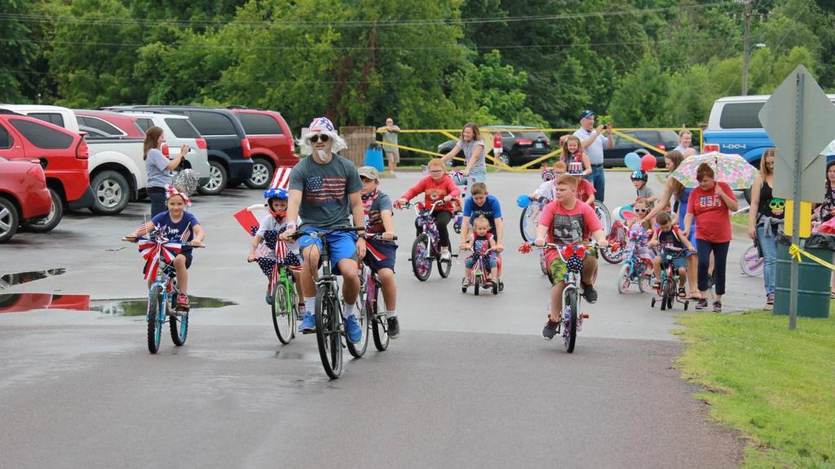 A bike parade kicked off the annual Fourth of July festival at Harrisonville City Park on Tuesday, July 4, 2017. A couple dozen children participated in the parade with their bikes decorated red, white and blue.
