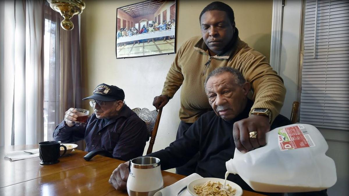 Veterans Roque Riojas (left), 93, and Theodosia Mobley, 84, live with caregiver Julius Anderson in his south Kansas City home. “I’m not going to tell you everything is peaches and cream,” said Anderson, 48, “... but we’re doing OK.”