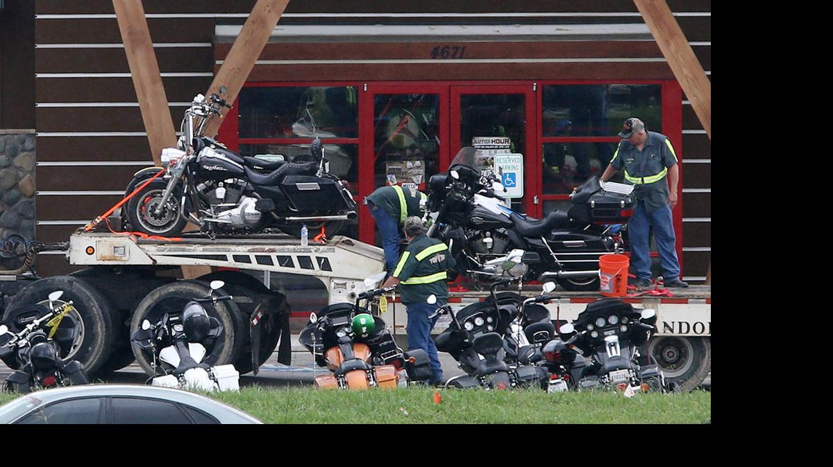
People load motorcycles on to a trailer in front of the Twin Peaks restaurant Monday, May 18, 2015, in Waco, Texas. About 170 members of rival motorcycle gangs were charged with engaging in organized crime Monday, a day after a shootout at the restaurant killed nine people and wounded 18.
