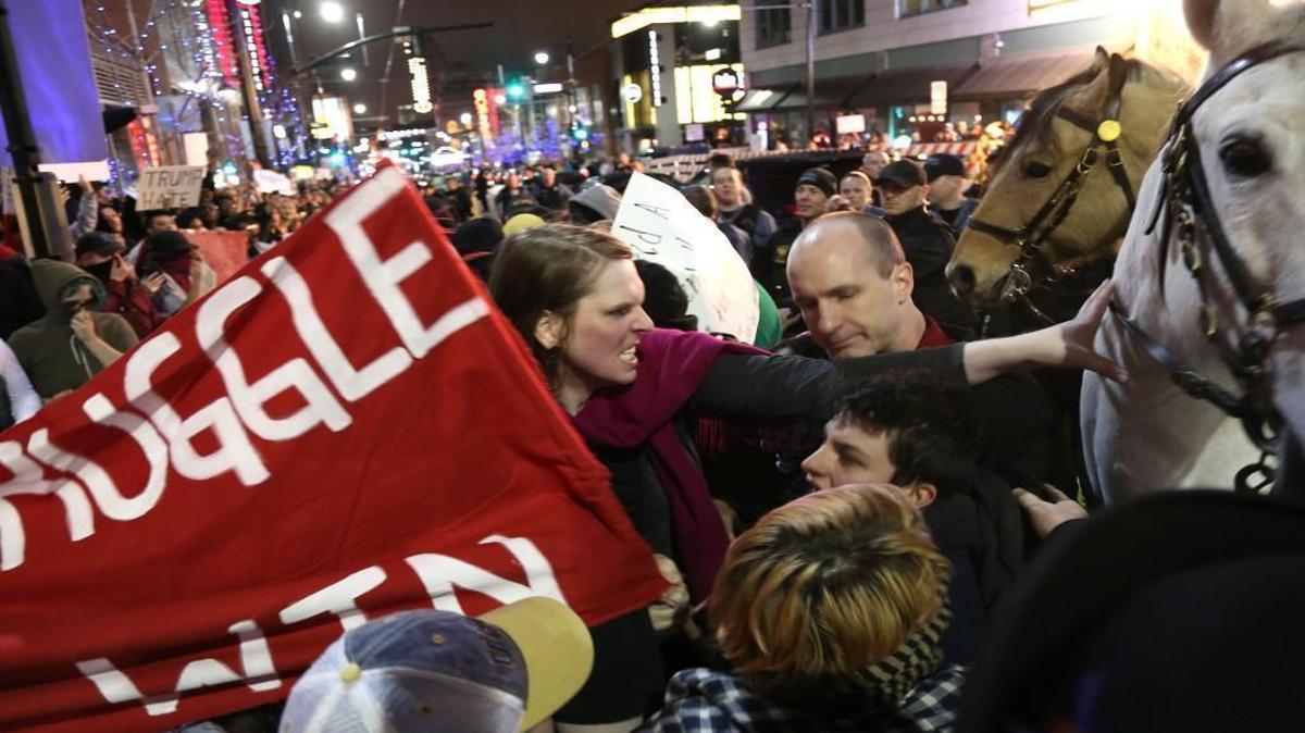 A protester pushed a police horse outside the Donald Trump rally March 12 in Kansas City.