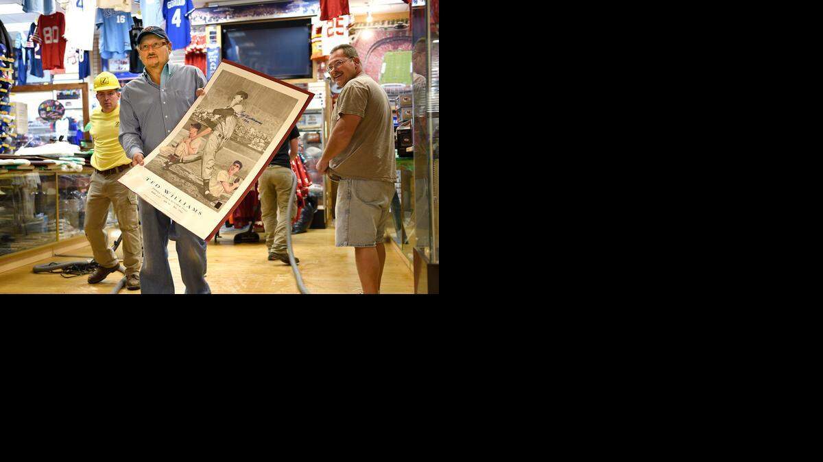
Hal Wagner, owner of Ace Sports & Tickets, retrieved an autographed lithograph print of famed baseball great Ted Williams from his store Wednesday after two fire suppression water lines burst, flooding the store and 11 others in the Barnes & Noble corridor at Oak Park Mall in Overland Park.
