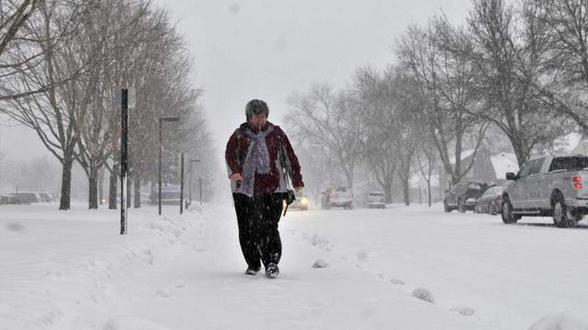 
Cheryl Kantor of Foley, Minn., walked outside St. Cloud Hospital on Monday. St. Cloud was forecast to get 10 to 16 inches of snow. The storm is threatening to bury several states in snow and drop thermometer readings in numerous states by as much as 40 degrees below average. 
