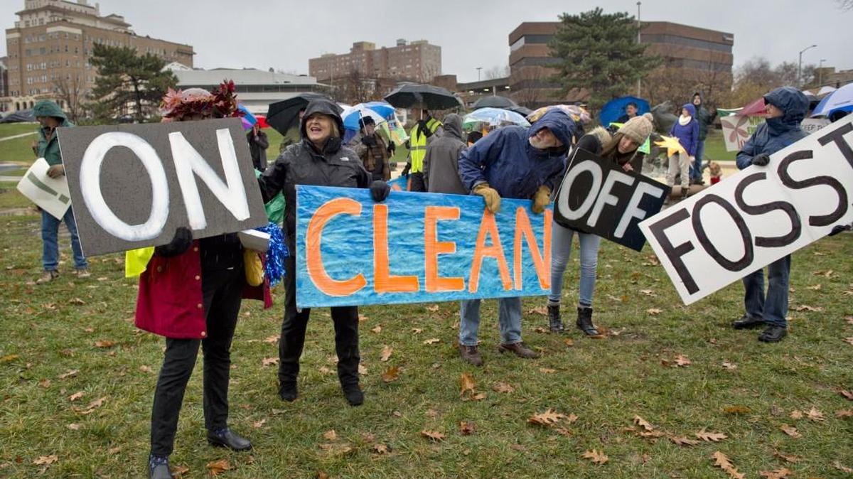 The Kansas City Climate Coalition marched on Sunday, Nov. 29, 2015, from the J.C. Nichols Fountain to the International Friendship Bridge over Brush Creek. Their message was “Turn off fossil fuels. Turn on clean energy.”