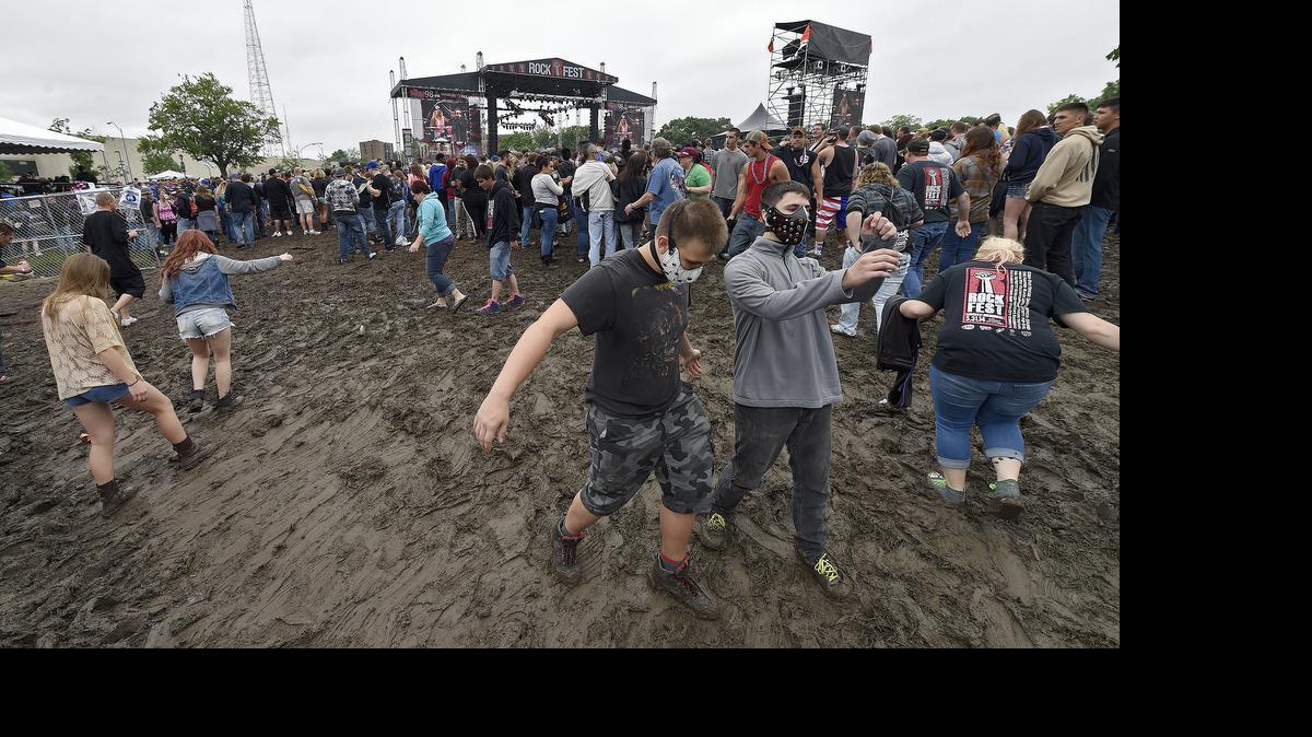 
Fans make their way along a muddy hillside during Saturday's Rockfest on May 30, 2015 at the Liberty Memorial in Kansas City, Mo.
