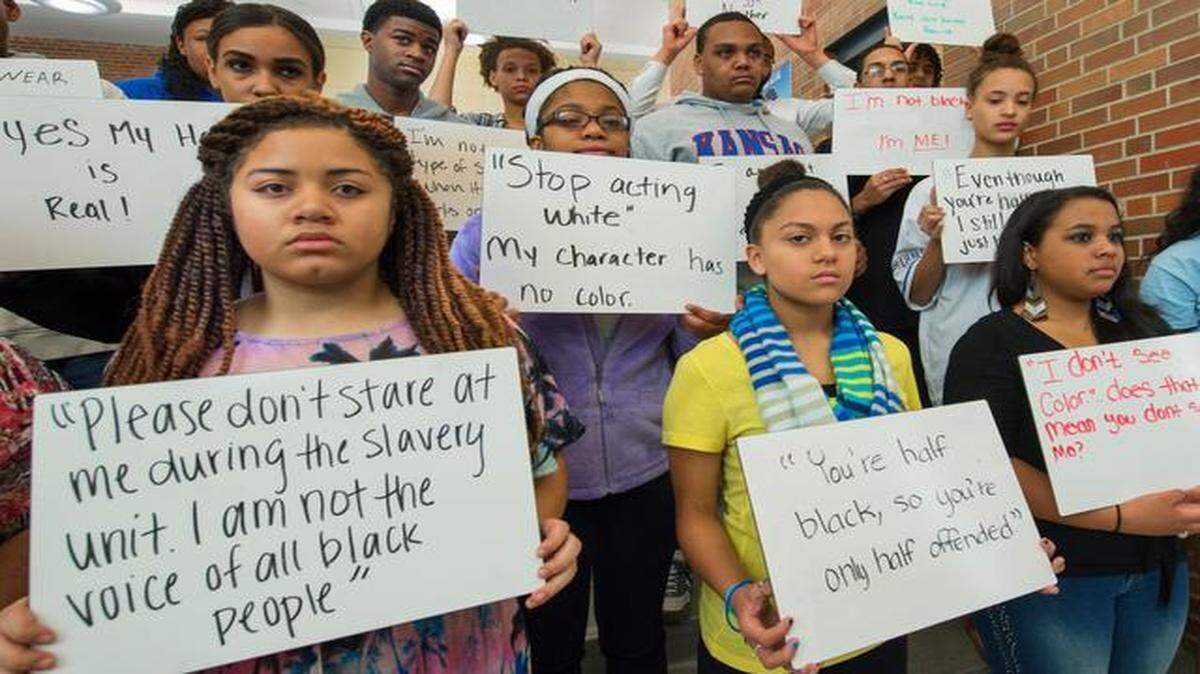 
Students at Shawnee Mission East High School in Prairie Village are launching an Instagram campaign in response to a racially charged Instagram post that surfaced last month using the N-word several times. On Wednesday, students and their teacher David Muhammad (back row, fourth from left) wrote placards that were photographed with each student and will be posted on the social media site Instagram. Each photo will have the hash tag #itooameast.
