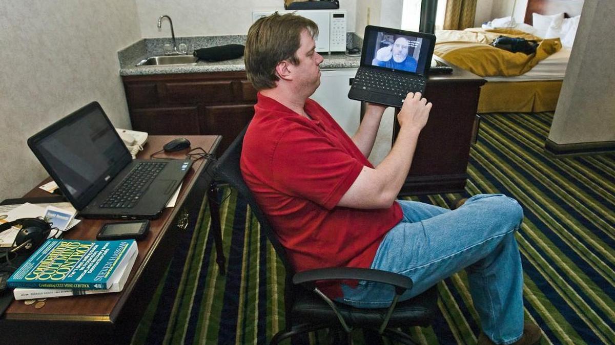 James Todd watches videos from the Fellowship of Martyrs YouTube site on Wednesday, Sept. 12, 2013, in his hotel room at the Quality Suites hotel near Kansas City International Airport.