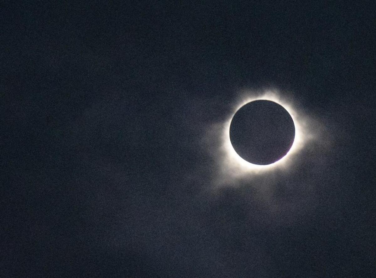 Despite cloud cover, the total eclipse shone through at Chicken ’N Pickle in North Kansas City on Monday.