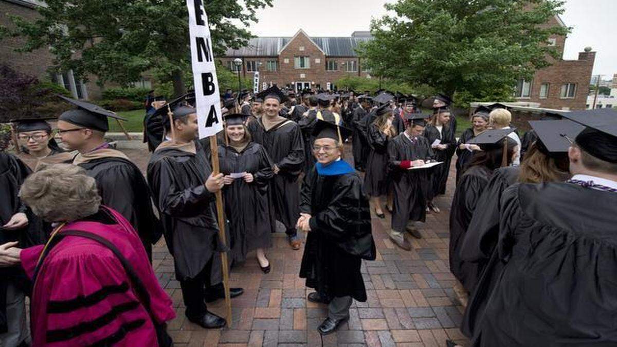 
Experts consulted by The Star said the study in question appeared to have been designed to award top rankings to the University of Missouri-Kansas City and Michael Song, the professor then in charge of the university’s Regnier Institute for Entrepreneurship and Innovation. Last May, Song (center) took part in spring commencement for UMKC’s Henry W. Bloch School of Management.
