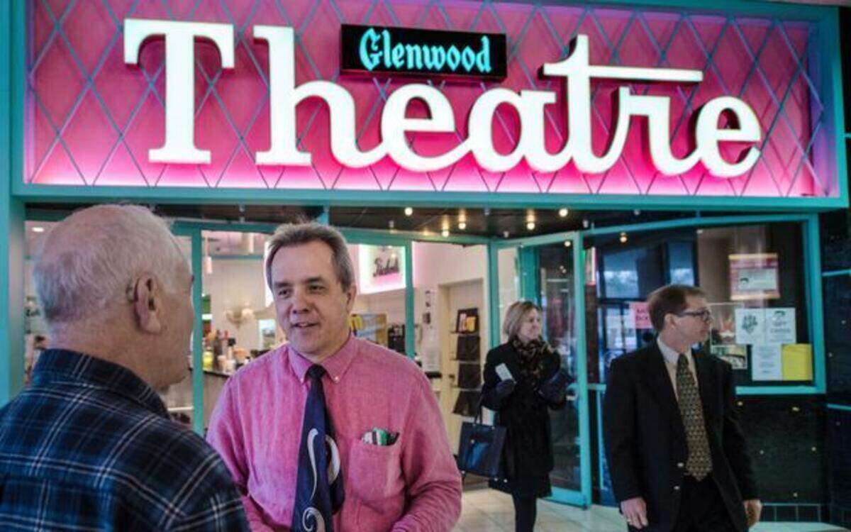 
Brian Mossman (second from left), co-owner of Fine Arts Theatre Group, which owns the Glenwood Arts Theatre in Overland Park, spoke with Frank von Geyso of Leawood on Sunday. The theater held its final showings at its Metcalf South Shopping Center location on Sunday.

