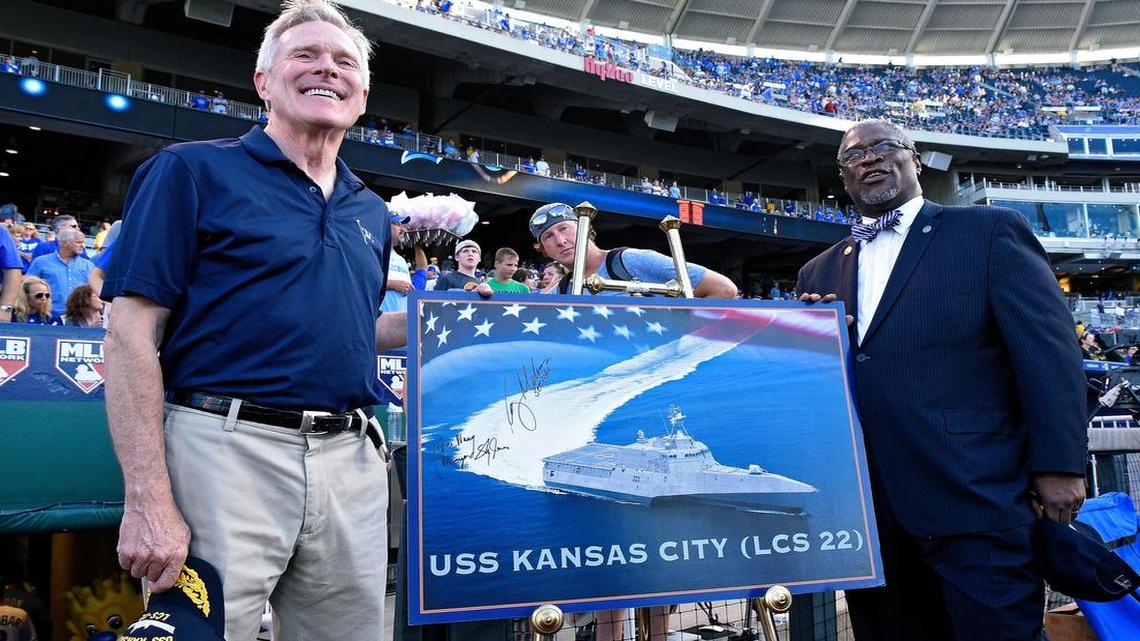 
U.S. Navy Secretary Ray Mabus, left, and Kansas City Mayor Sly James showed off a picture of the future USS Kansas City on Monday before the Royals game against the Pittsburgh Pirates.
