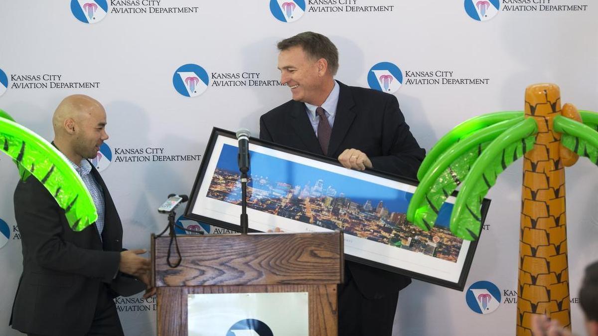 
Lukas Johnson (left) of Allegiant Air received a framed poster of Kansas City from Mark VanLoh of the Kansas City Aviation Department after Johnson announced new nonstop flights to three destinations in Florida from Kansas City International Airport beginning in November.
