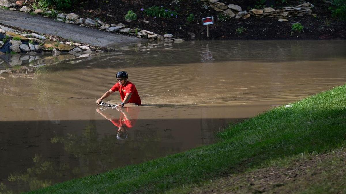 
Mountain biker Tony Claypole rode through standing water behind the Hall of Waters on Sunday afternoon in downtown Excelsior Springs. Heavy rains earlier in the day caused flooding in the area.
