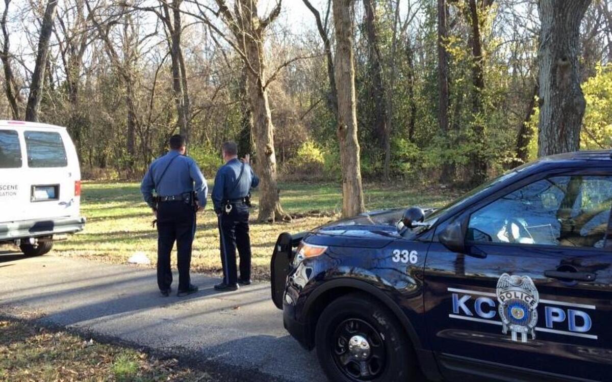 Police investigators on Sunday carried evidence out of a wooded area near Interstate 29 and North Highland Avenue, where human remains were found.