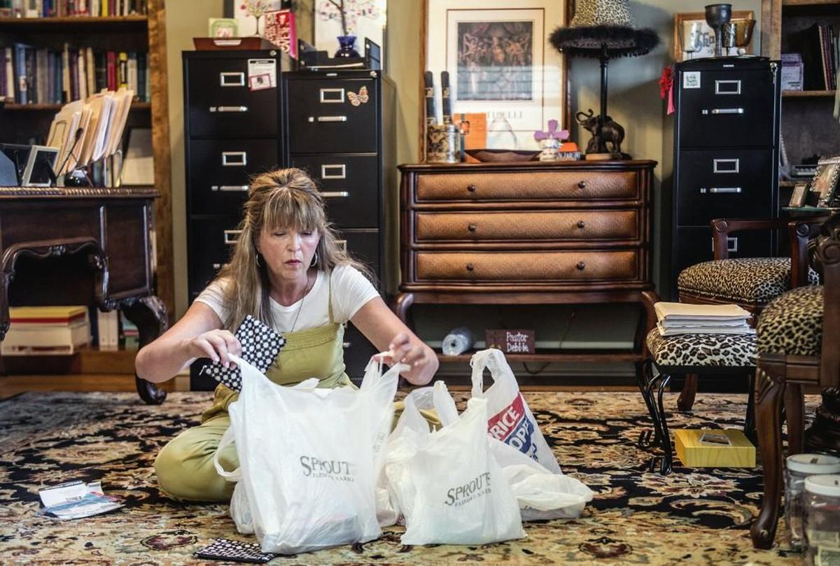 Inside her Olathe home, the Rev. Debbie Buchholz prepares care packages for deaf refugees before heading to Kansas City, Kan., for an American Sign Language class for the refugees. Buchholz, who is hard of hearing herself, runs a program for deaf refugees through her Olathe church.