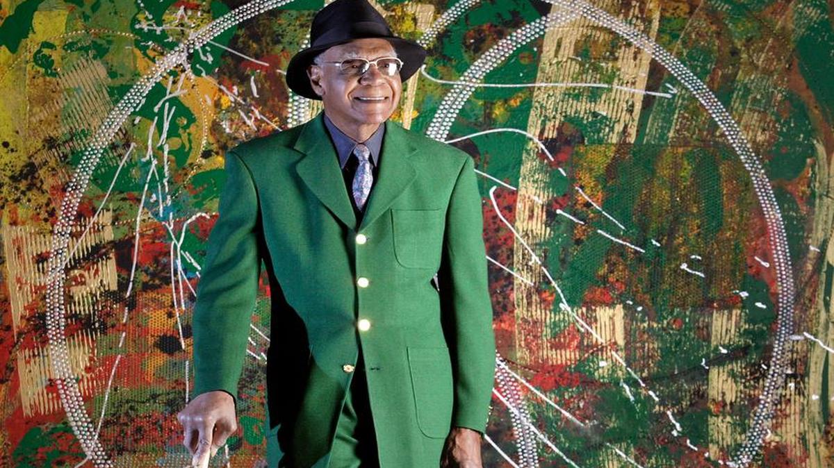 
Buck O'Neil posed in front of the Anthony Ramos painting "Oilcan Boyd" on Wednesday, Feb. 22, 2006, at the Negro Leagues Museum.
