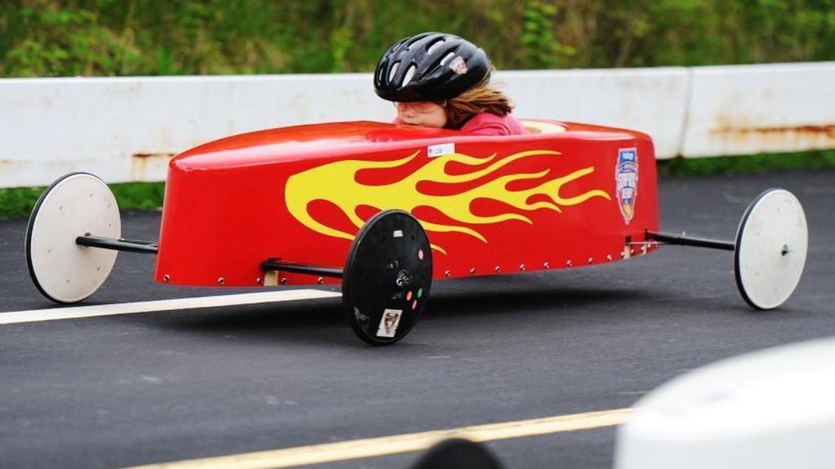 Anna Roth, 7, of Kansas City neared the finish line in her hot-rod-style car as she raced against Carlie Kilby of Independence, Iowa, Sunday at the Kansas City Soap Box Derby races at the track near the Truman Sports Complex.