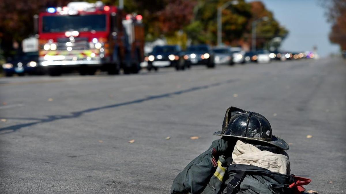 
Out of respect for their fallen comrade, Kansas City firefighters placed a helmet and bunker gear in front of Station 17 as the funeral procession for Larry Leggio passed Monday afternoon near 34th Street and the Paseo. Leggio and fellow firefighter John V. Mesh were killed last week while battling a blaze in the 2600 block of Independence Avenue in the city’s Northeast area.
