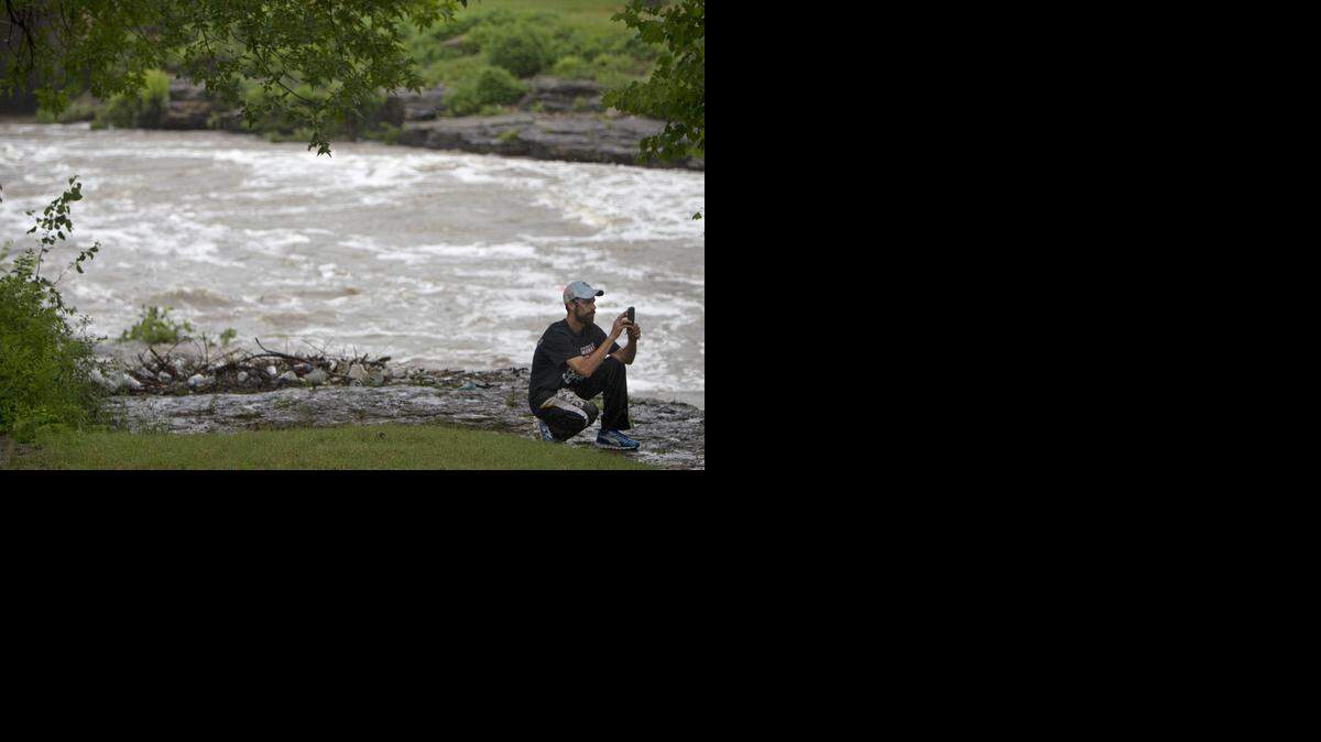 
After heavy overnight storms, an onlooker paused in the rain on Tuesday to photograph the rapidly moving waters of Indian Creek near the Watkins Mill Park, off of 103rd Street, just east of State Line Road in Kansas City.
