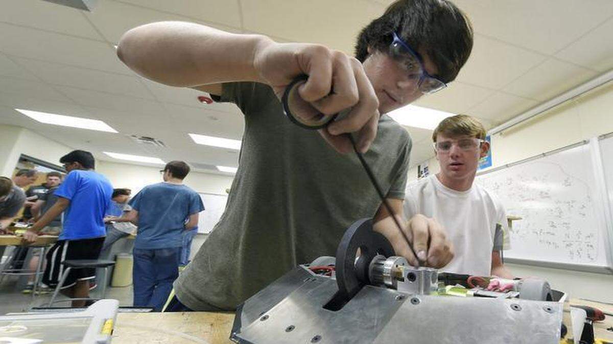 
Seniors Daniel Baker (left) and Lee Fitchett worked on their battle bot during a class at Olathe Northwest High School. Their team, with its creation, will participate in a National Robotics League competition at the high school Saturday.
