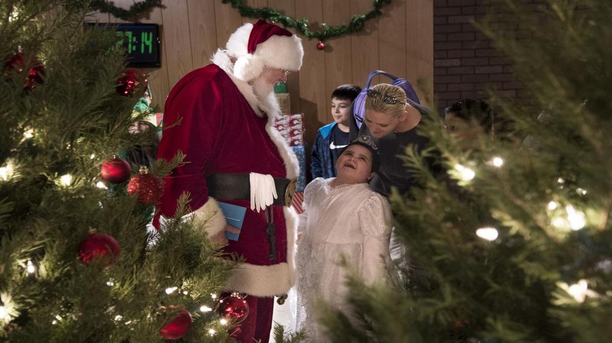 Santa Claus smiled as Caroline Lopez, a snow princess for the day, looked up at her mother during her tour of the North Pole with the Elves of Christmas Present on Christmas Eve.