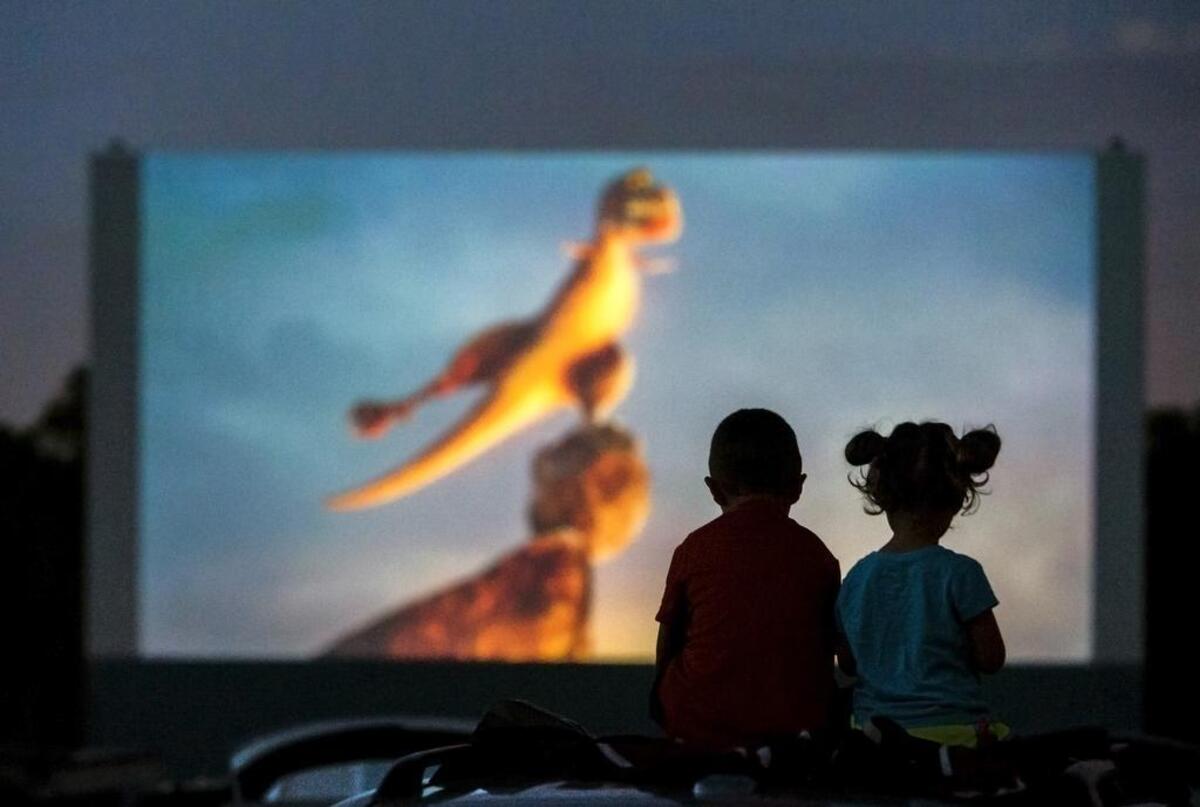 Luke Peschel, 7, and sister Ellen, 3, of Manhattan, watch the movie “Minions” on the roof of their parents’ SUV on Saturday, July 11, 2015, at the Boulevard Drive-in, 1051 Merriam Lane, in Kansas City, Kan. Sixty-five years after opening the theater, owner Wes Neal, 87, continues to take tickets and roam the grounds, but he has handed over most the business to his grandson, Brian Neal.