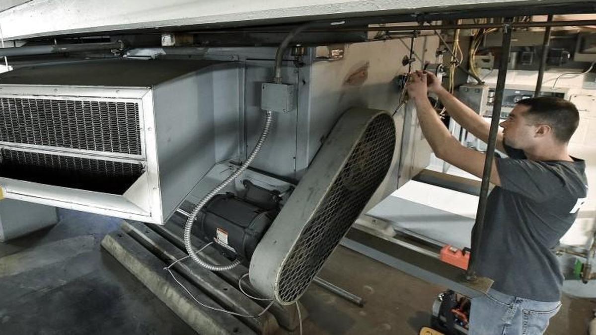 Matt Hanschu worked on a control system for a heating unit in the garage of the Wornall Plaza building, 310 W. 49th St., in December 2014.