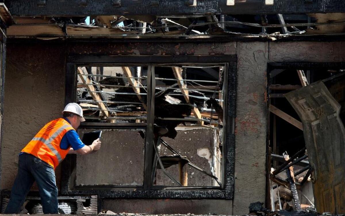 
After Tuesday's fire at the Jefferson Park Apartments in Liberty, Cary Case of Bear Claw Construction Management recorded the damage as the company began securing the building.
