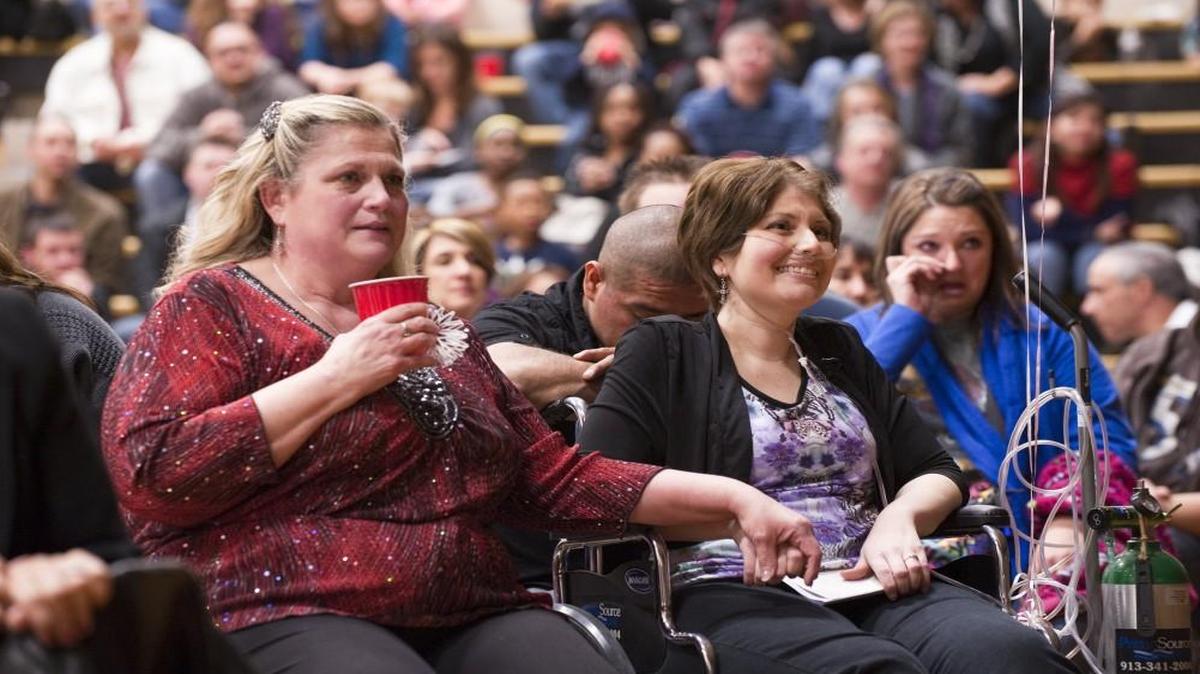 Noma Dobbs (left) held her daughter’s hand as they watched a slide show of Shannon Anaya’s life during a “celebration of life” party at Valley View High School on Feb. 23, 2013. Family and friends gathered to pay tribute to Shannon. At right is her son, Julio.