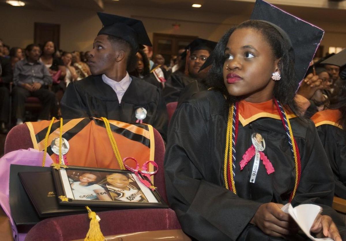 At Southwest High School graduation in 2016, India Woods sat next to chair that honored her late classmate, Daizsa Bausby.