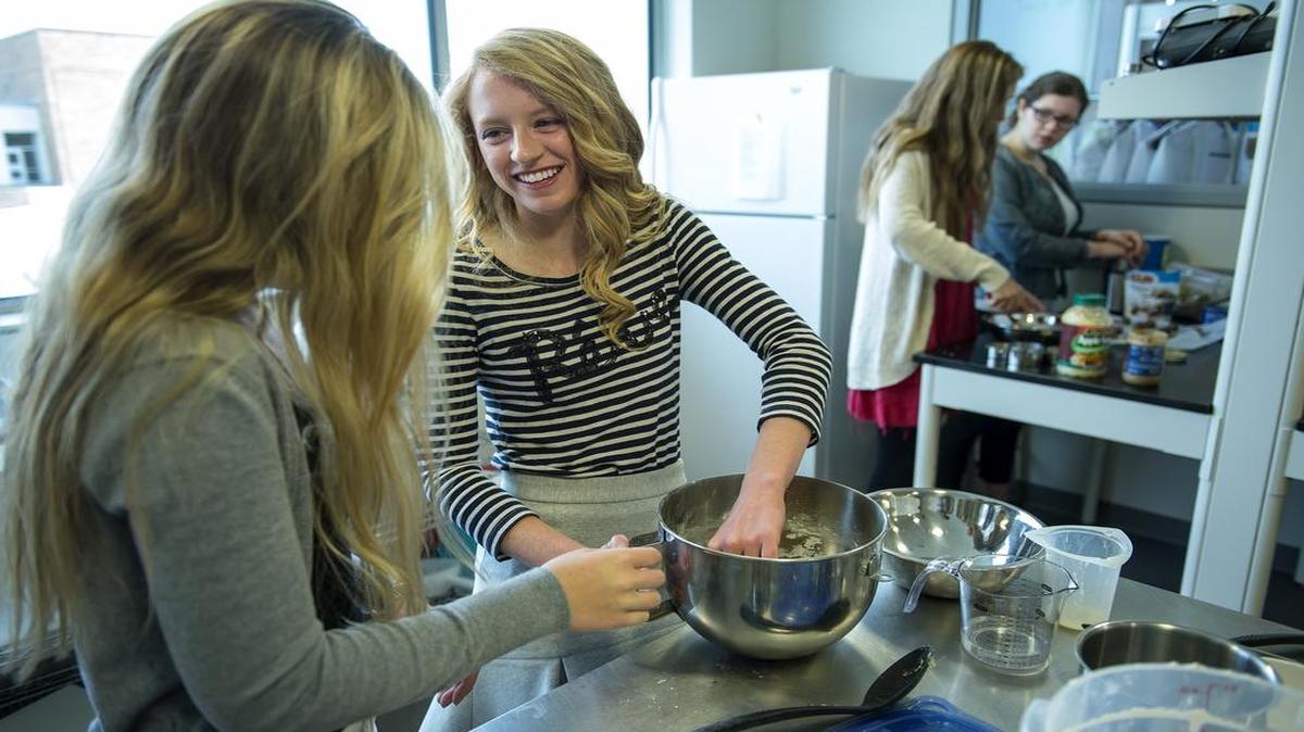 
Annie Morse (center) was a senior at Blue Valley Southwest in April when she worked on an apple pie cinnamon dessert pizza recipe with classmate Chloe Davis (left) in the Global Foods class at Blue Valley CAPS. 
