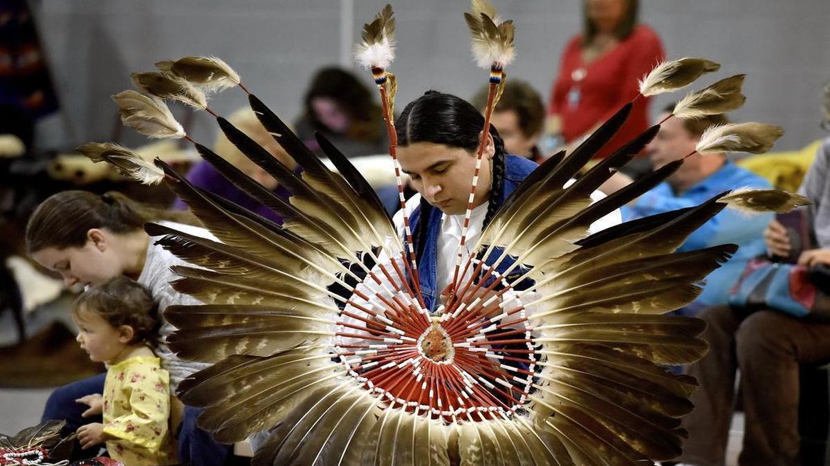 Justin Tone-Pah-Hote of Liberty, Mo, made adjustments to a feather bustle for his regalia during Saturday’s Indian Council of Many Nations Winter Powwow at the Missouri National Guard Armory, 7600 Ozark Road in Kansas City. Tone-Pah-Hote was also the head man for the event.