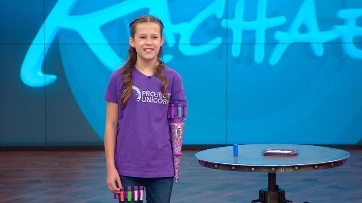 Jordan Reeves, who’s from Columbia, Mo. shows off the prosthetic glitter dispenser she designed, on the Rachael Ray show this week