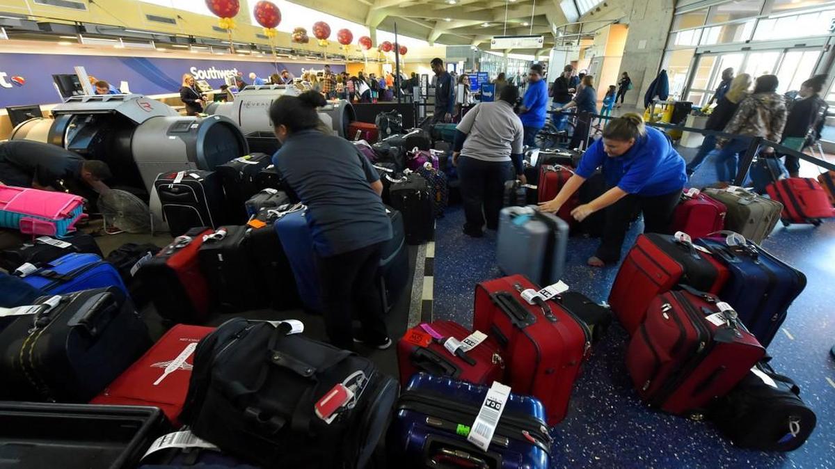 Kansas City International Airport was a busy place Tuesday as the Thanksgiving holiday approached. Airport employees organized bags that needed to go through X-ray screening in Terminal B by the Southwest Airlines ticket counter.