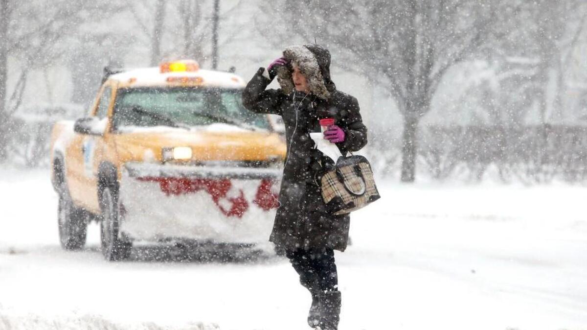 Erica Linfante of Morristown, N.J., battles the elements there as several inches of snow was forecast in the area.