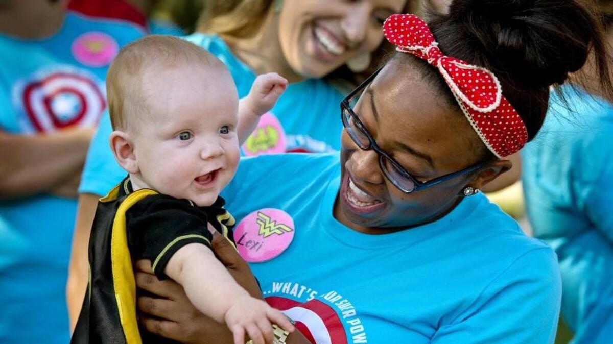 Brayden Smith, 7 months old, got to visit with Lexi Wright, an assistant in the neonatal intensive care unit at Shawnee Mission Medical Center, during the unit’s eighth annual reunion celebration on Sunday. His parents are Larissa and Dennis Smith of Olathe.