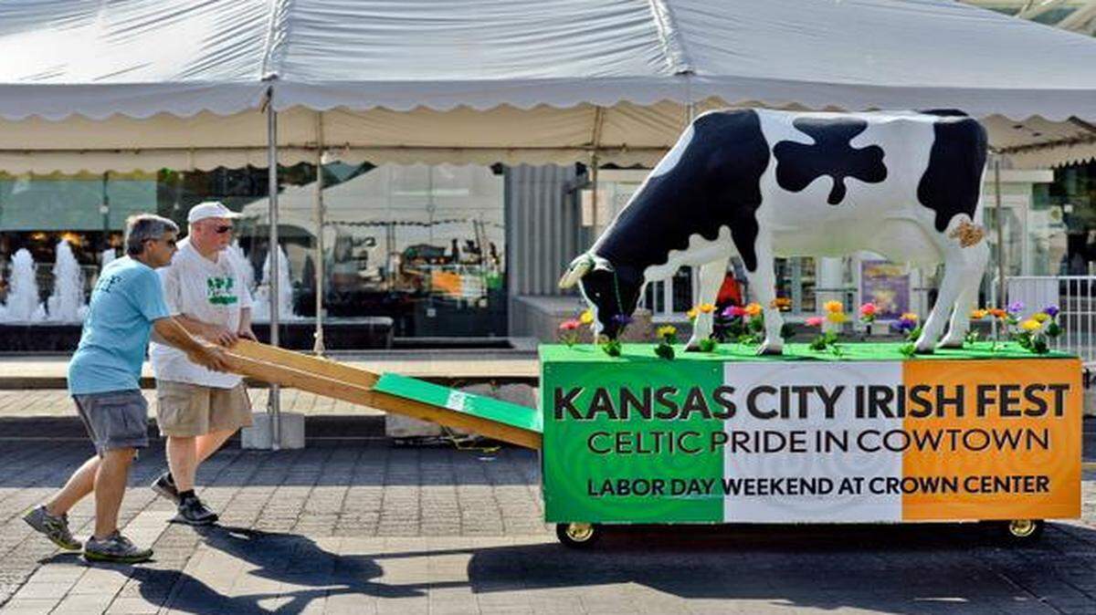
Brian McCarthy (left), and Ed Follis push a cow on Thursday during setup for the Kansas City Irish Fest at Crown Center. The cow was created by festival designer Dan Regan and is meant to embody the Irish spirit and Kansas City. The festival features food, shopping and music and is open 5-11 p.m. Friday and 11 a.m.-11 p.m. Saturday and Sunday.
