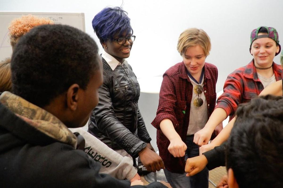 Josie leads a prayer with friends at the KC Passages program for LGBTQ+ teens. The program, facilitated by the KC Anti-Violence Project, is one of the few spaces where Josie says she feels completely safe.