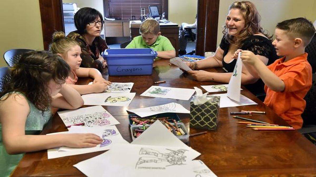 
Nicole Staller of Independence is in a good place with her children and life with the help of CASA volunteer Kate Beem. Beem (third from left) and Staller (second from right) helped color with Staller’s children Lauren (from left), 8; Stella, 7; Matthew, 9; and Hayden, 5.
