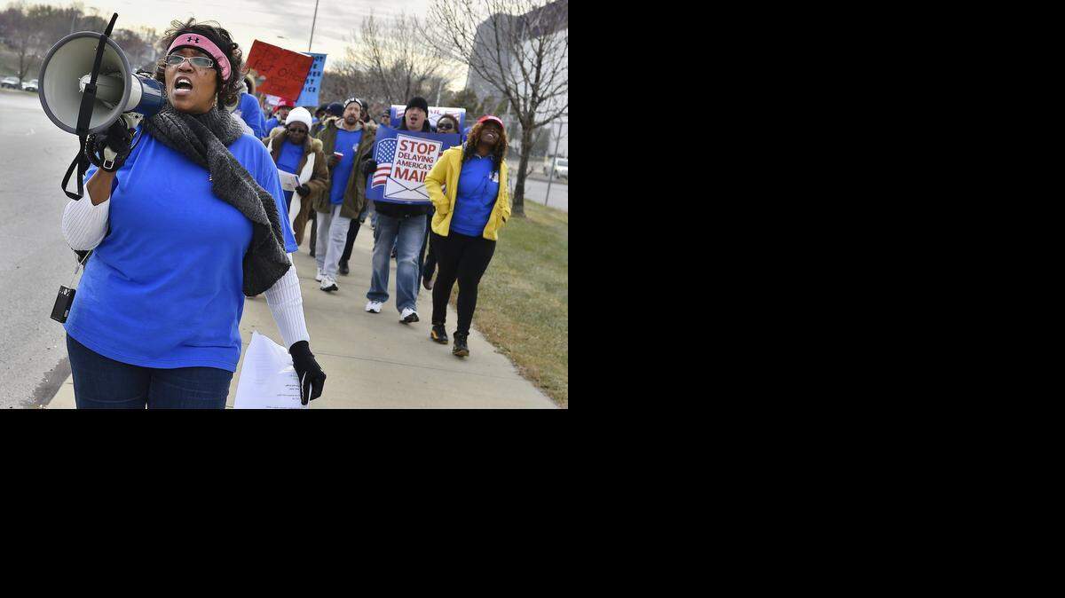 
Postal workers, unions and supporters rallied against the upcoming changes to services and facility closures Friday near a postal processing plant at Truman Road and Cleveland Avenue in Kansas City. Antoinette Robinson, president of the American Postal Workers Union Local 67, shouted chants as she led demonstrators from the plant to the higher-visibility corner.
