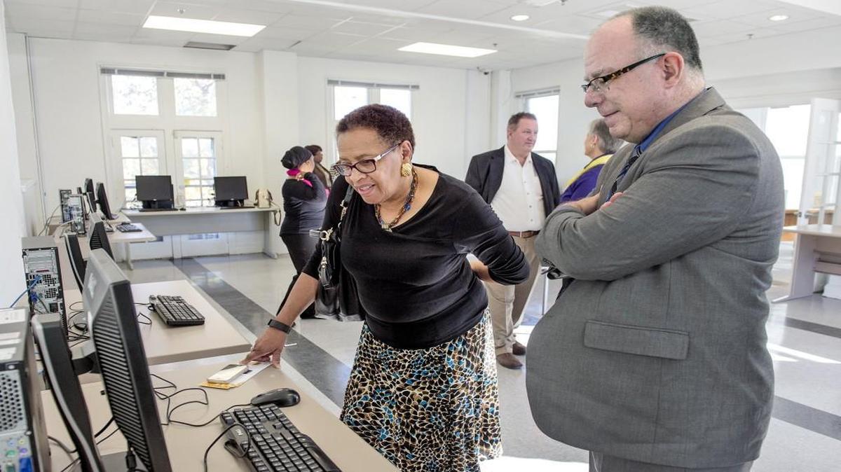 Michael Liimatta, CEO and co-founder of Connecting for Good, showed programs on the computer to Lujean King of Grandview on Sunday during the grand opening of Connecting for Good’s Linwood Area Computer Center at 3201 Michigan Ave. in Kansas City.