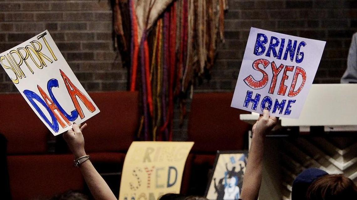 Signs of support are held at a "Free Syed" rally at the All Souls Unitarian Universalist Church in Kansas City Sunday, Feb. 11, 2018. ICE arrested Syed Ahmed Jamal, a native of Bangladesh, in January.