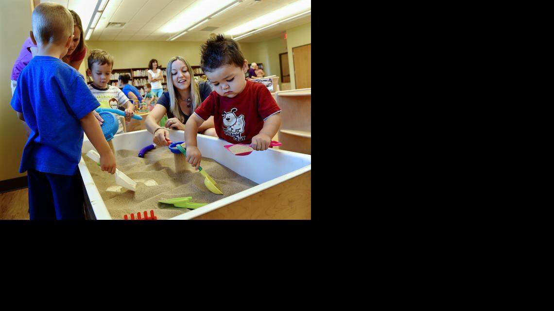
The Blue Valley School District has transformed what used to be First Family’s megachurch into the Hilltop Campus. On Monday, members of the PTA and Parents as Teachers got a sneak peek of the facility during a playgroup. Two-year-old Dade Lo (from right) of Overland Park; his mother, Sandra Lo; 3-year-old Parker Smith and his mom, Amy Smith; and Gavin Beardsley, 4, played in the sandbox.
