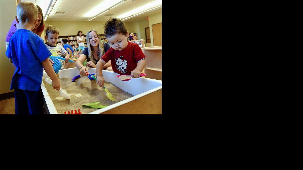 
The Blue Valley School District has transformed what used to be First Family’s megachurch into the Hilltop Campus. On Monday, members of the PTA and Parents as Teachers got a sneak peek of the facility during a playgroup. Two-year-old Dade Lo (from right) of Overland Park; his mother, Sandra Lo; 3-year-old Parker Smith and his mom, Amy Smith; and Gavin Beardsley, 4, played in the sandbox.
