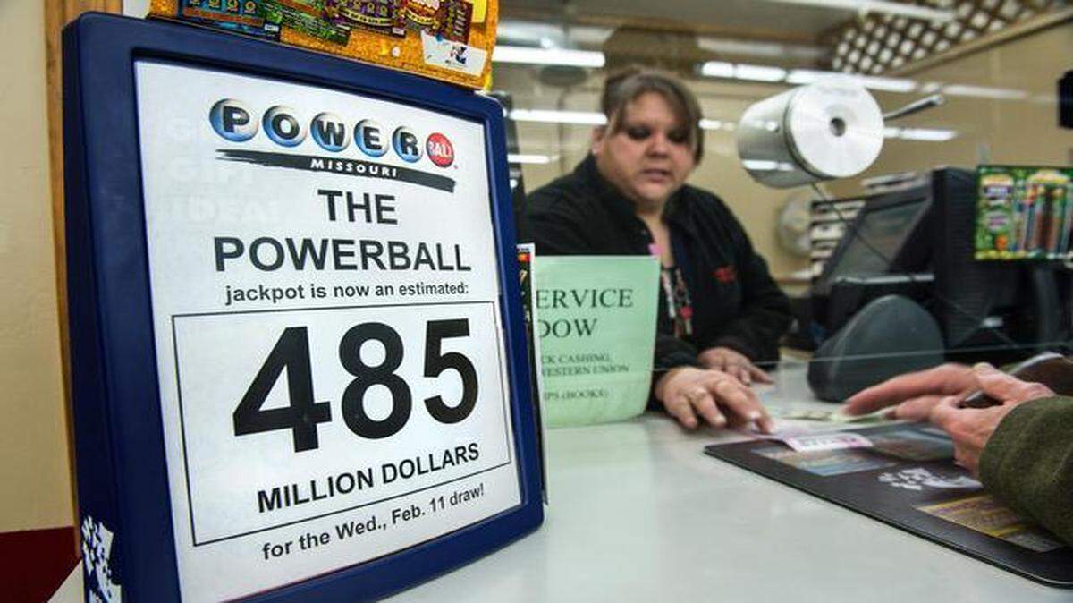 
Tiffany Brown, a clerk at the Red X store in Riverside, handled a line of customers wanting Powerball tickets on Wednesday morning prior to the night’s drawing for a jackpot that was estimated at $500 million.
